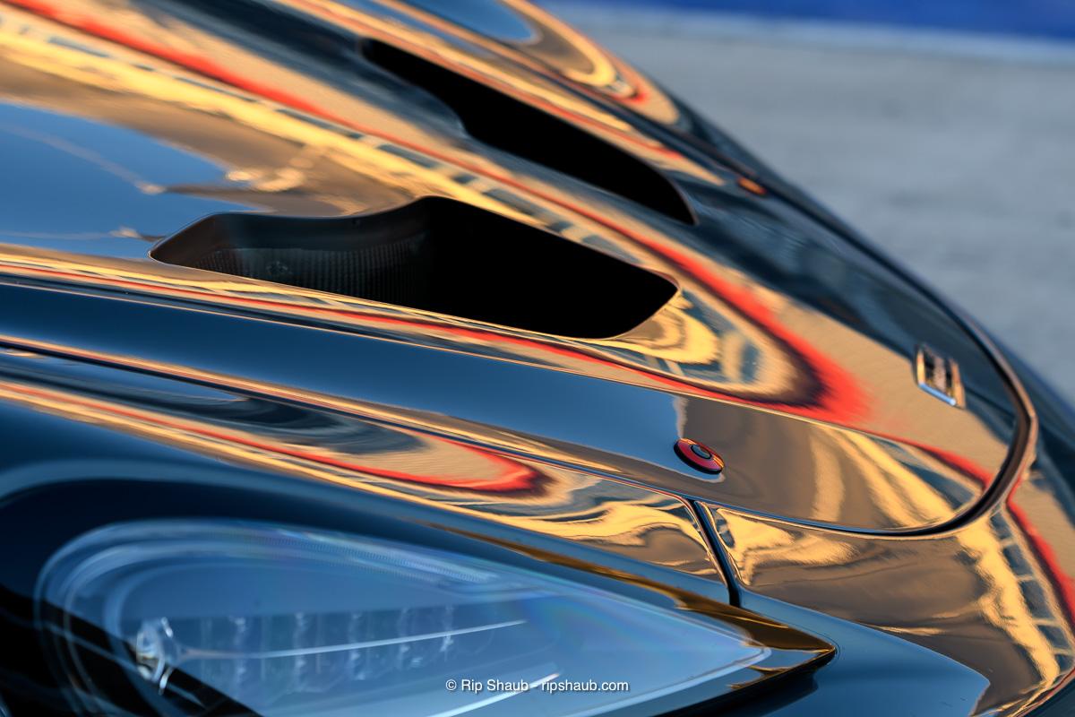 The grandstand reflection can’t compete with the gaping carbon fiber black holes of the hood scoops. , <i>© Richard Shaub. All Rights reserved</i>