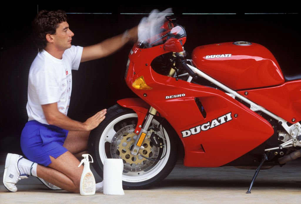 1994: Cleaning his Ducati motorbike at his home in Brazil