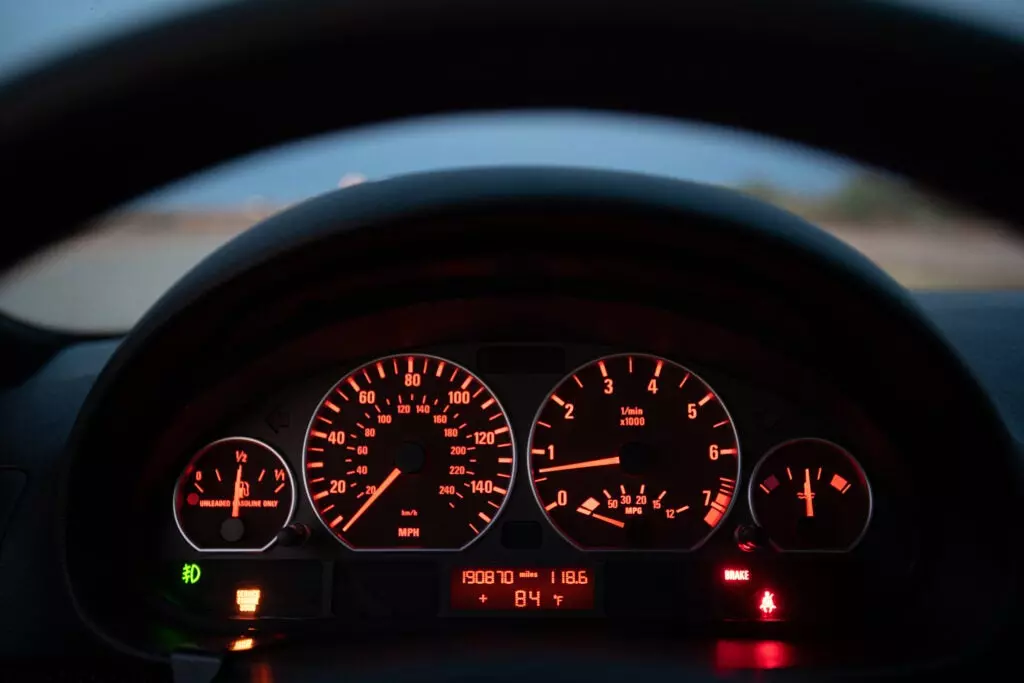 E46 BMW ZHP dashboard detail showing service engine soon light.