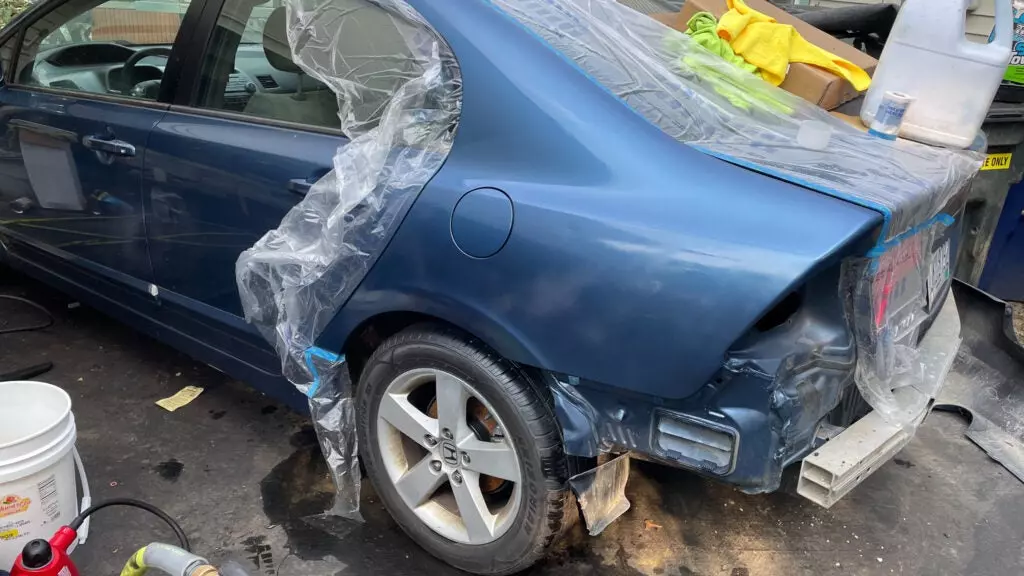 Civic in progress of painting rear quarter panel