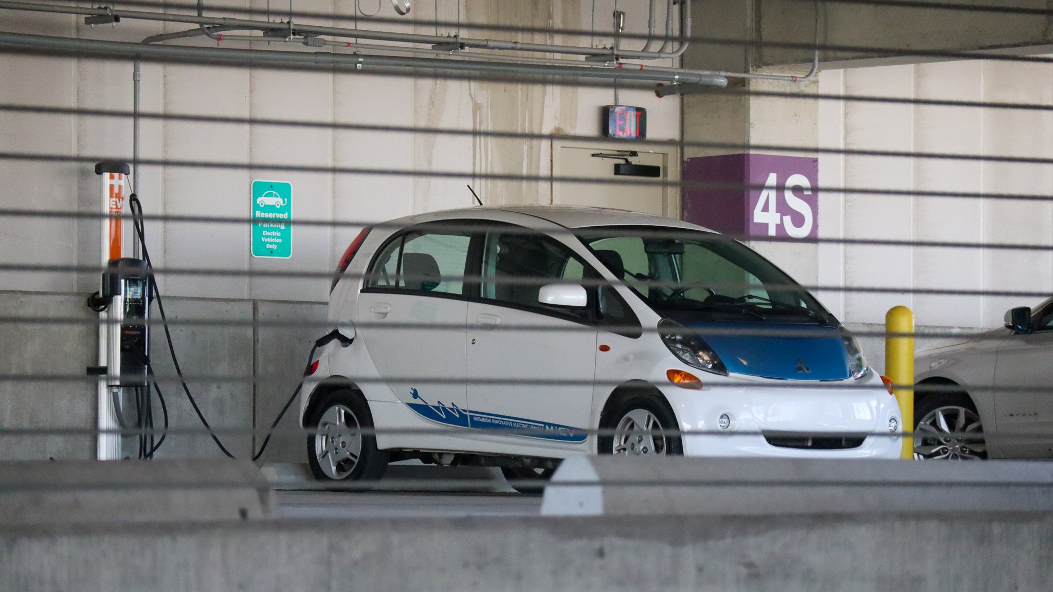 Mitsubishi i-MiEV Charging, behind wire barrier.