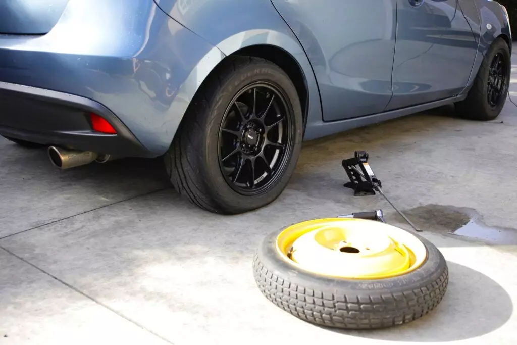 how to change a tire flat tire mazda2