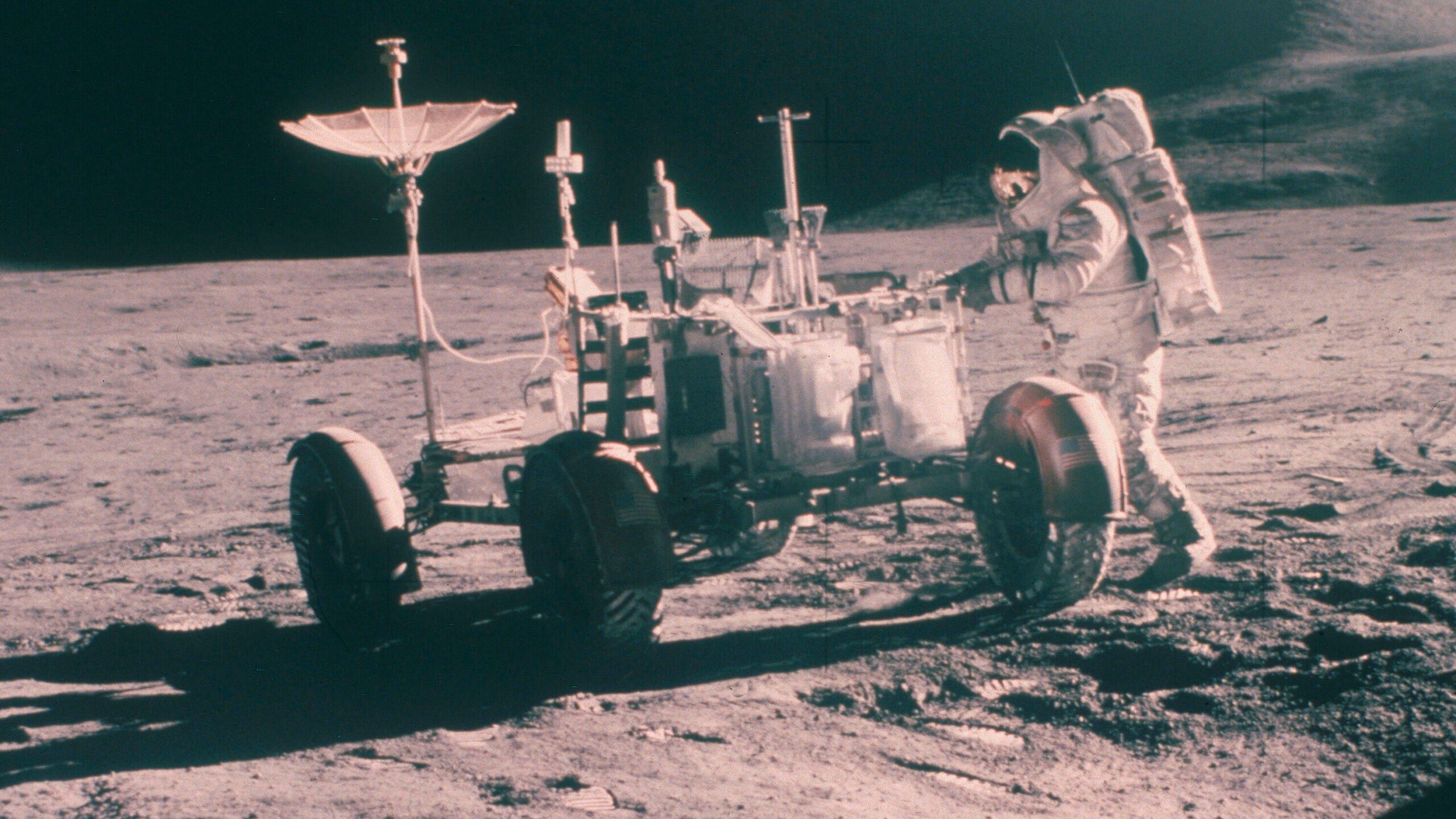 Apollo 15 astronaut James Irwin, with the Lunar Rover with Mount Hadley in the background, August 1971 <em>Oxford Science Archive/Print Collector/Getty Images</em>