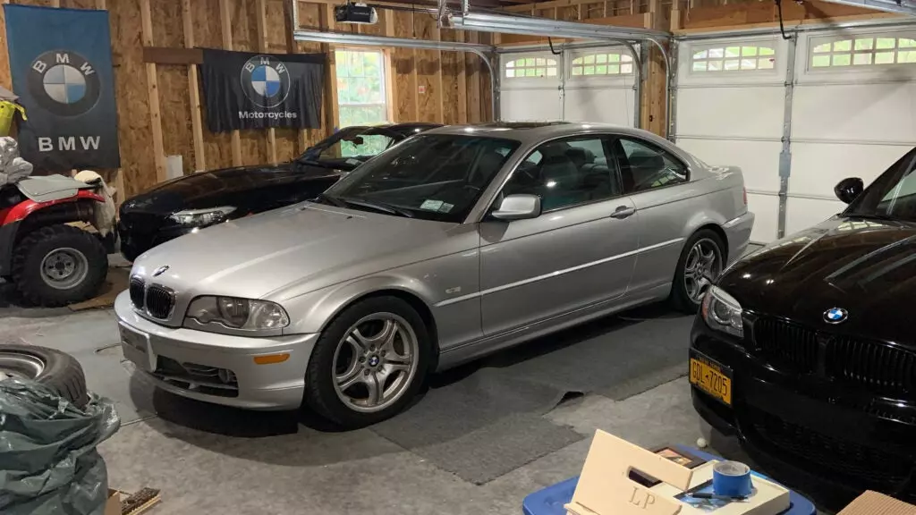 A silver BMW E46 parked among other BMWs