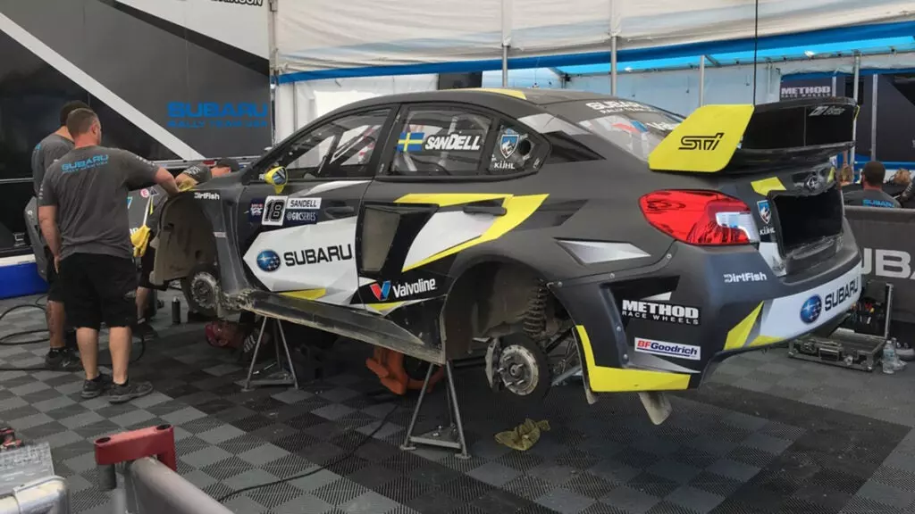 A Subaru WRX STI racecar on jack stands.