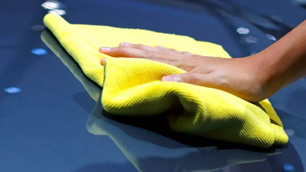 A microfiber towel on shiny car paint.