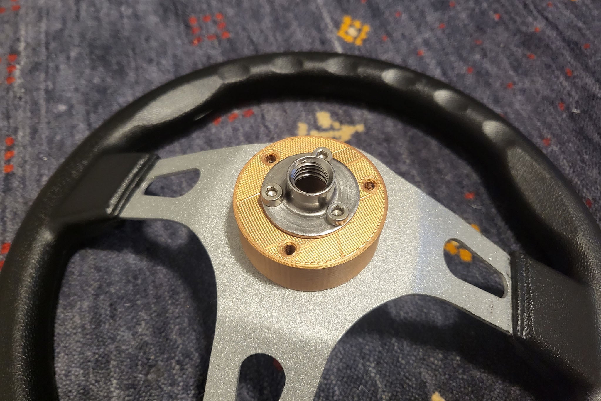 The only 3D-printed part of the kart is the steering adapter, which allows the wheel to bolt up to the smaller screw-mount nuts I used for most of the steering.
