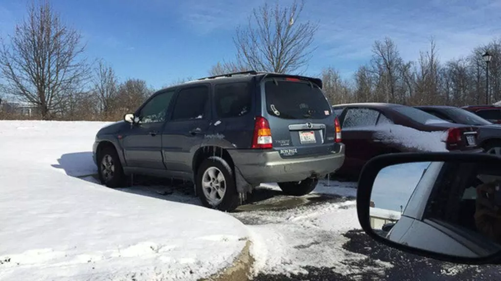 A Mazda Tribute in a snowy parking lot.
