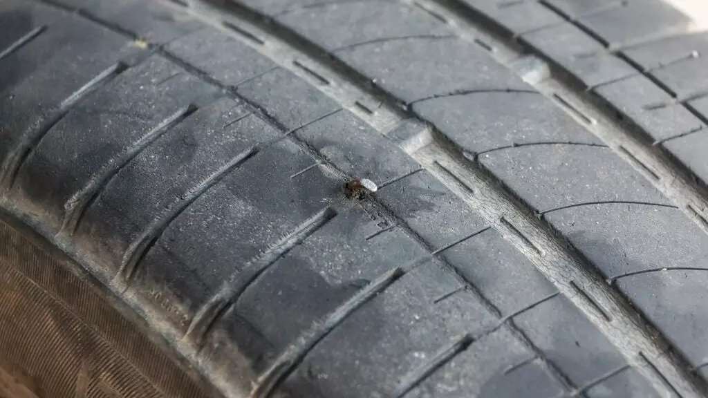 Close-up of a nail in a tire.