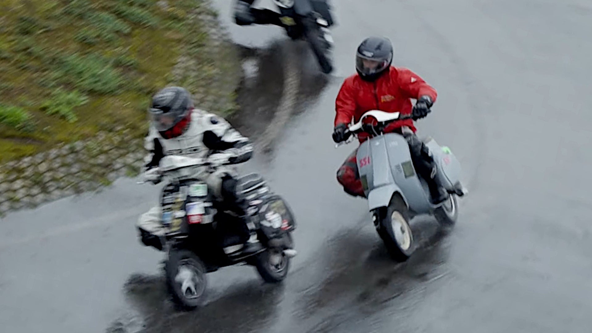 Watch a Bunch of Vespas Racing on a Rain-Soaked Circuit